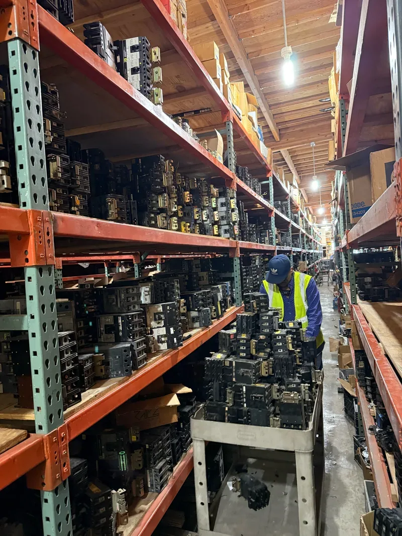 An aisle of drawout breakers awaiting resale
