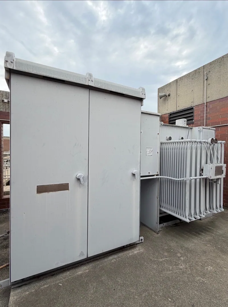 An outdoor walk-in enclosure at a substation