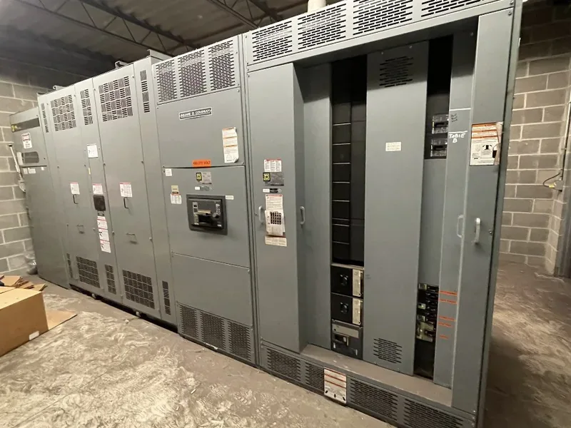 A switchgear lineup in a plant room before removal