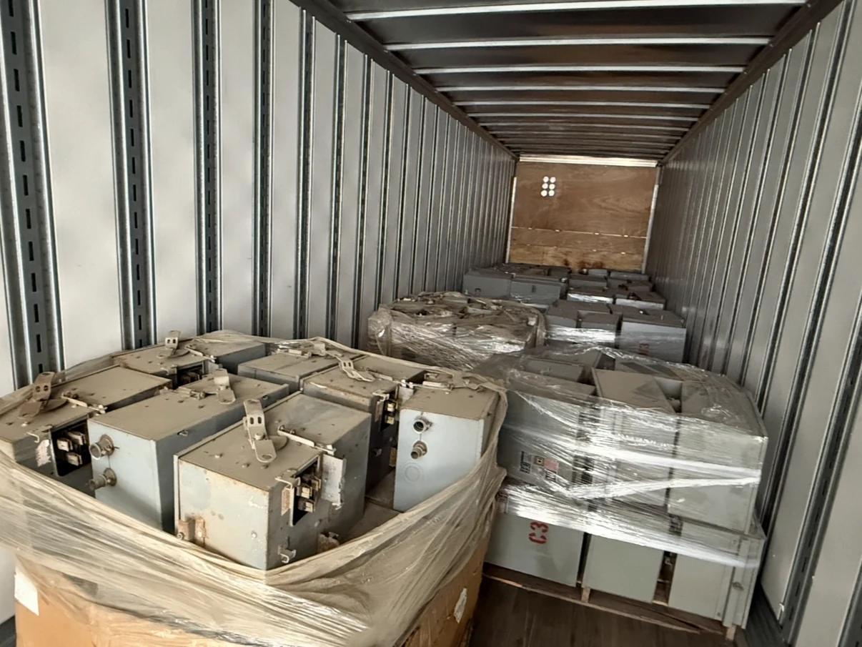 Wrapped pallets of electrical equipment loaded inside a transport trailer.