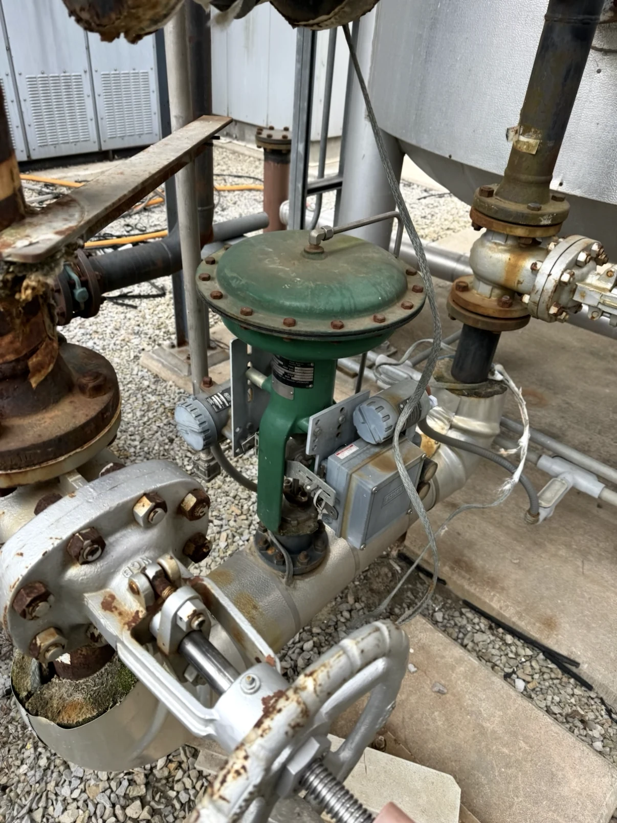 Green pneumatic control valve installed on industrial piping.