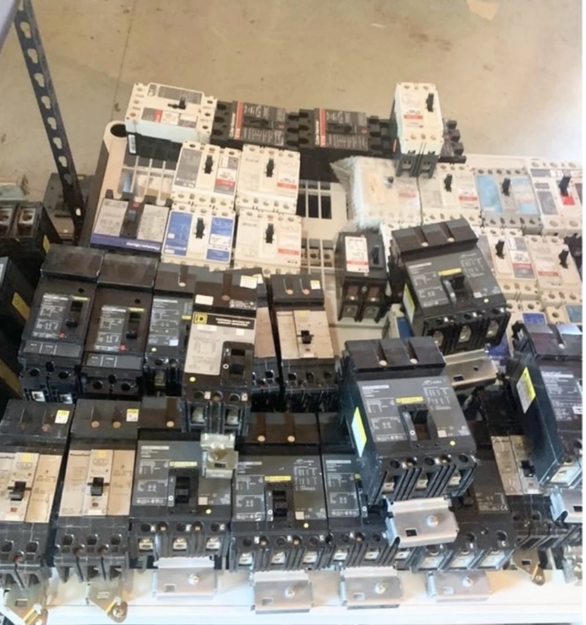 Collection of molded-case circuit breakers in varied sizes.